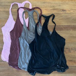 Four Lululemon Lightweight Tanks.